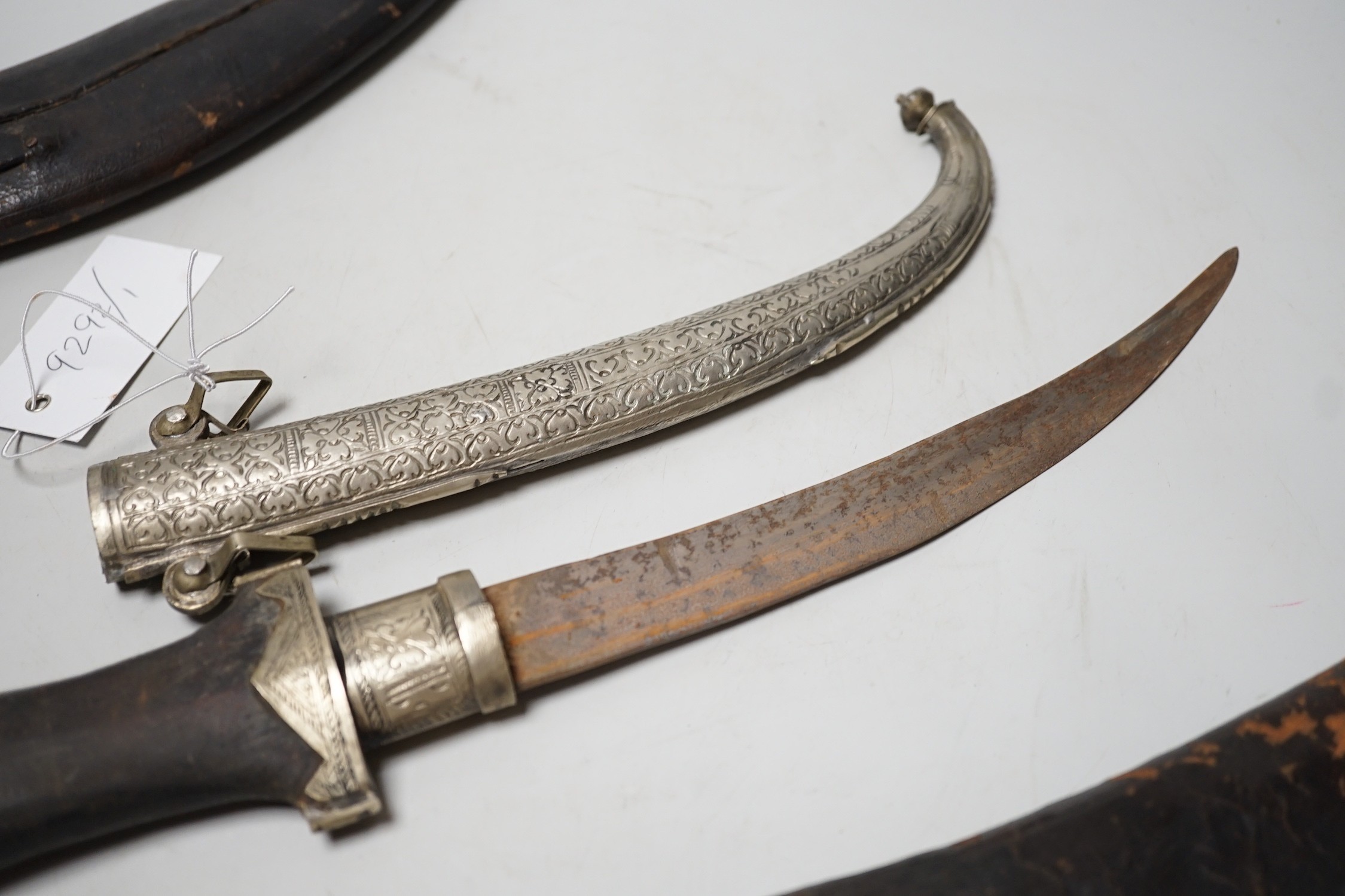 Two Kukri and eastern daggers, within engraved sheath, (3)